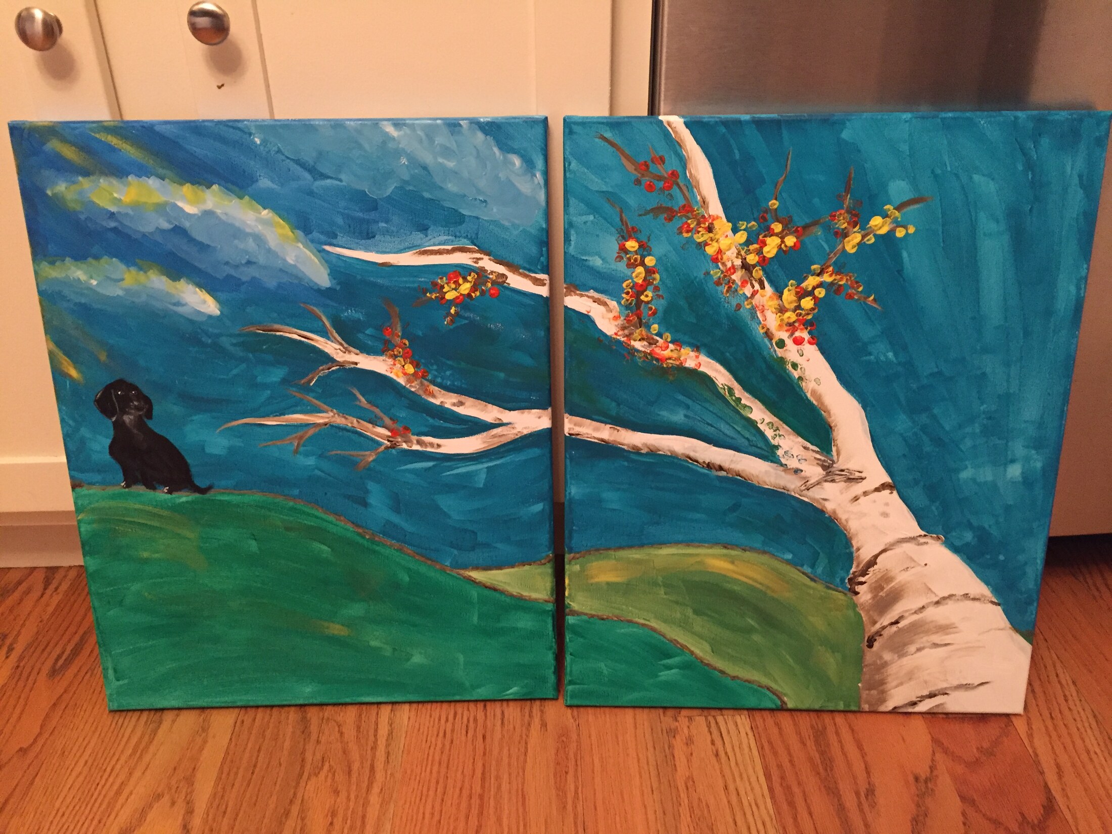 Two-panel painting of a windswept white birch and a small black dog beneath a turquoise sky