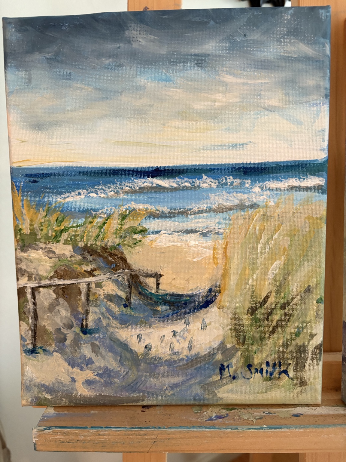 Mary's painting of a hammock nestled between grassy dunes with ocean waves beyond