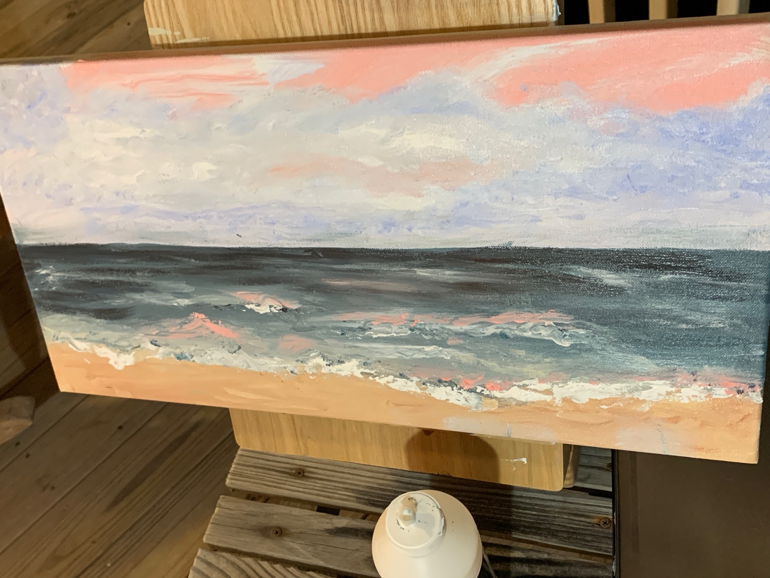 Mary's shoreline painting with blue-gray waves and blush pink light across the sky